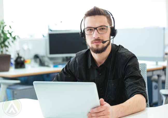 serious call center agent using laptop