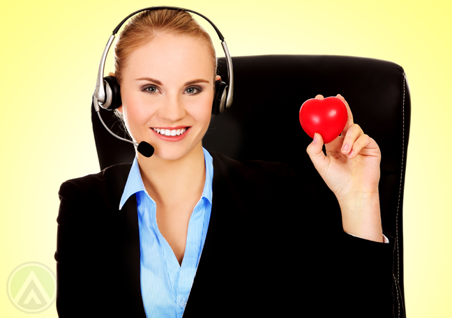 smiling blond call center agent holding rubber heart