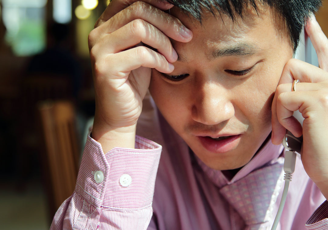 worried man speaking to call center on the phone