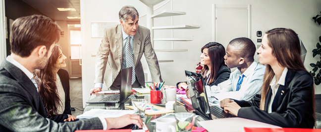 boss conducting meeting with culturally diverse business team