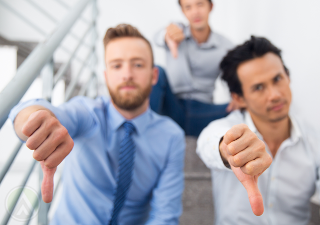 business group giving disapproving thumbs down in fire escape