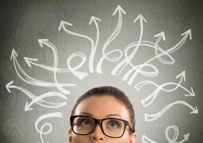 confused business executive looking up at swirly arrows from head