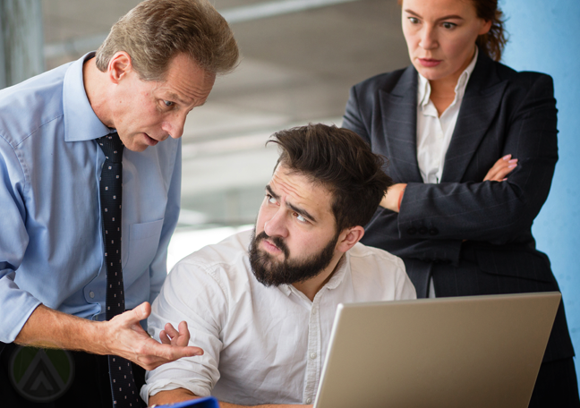 coworkers arguing by laptop 