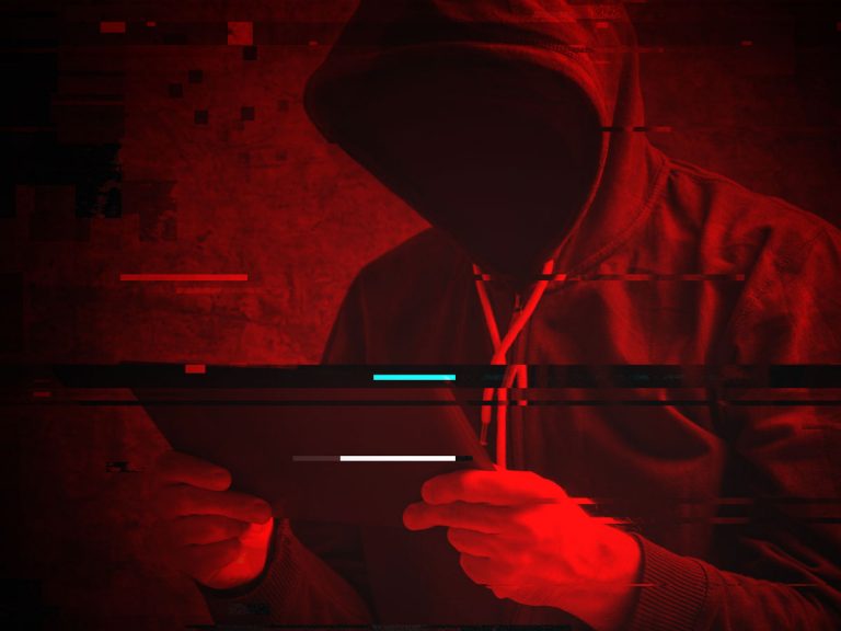 cybercriminal in hoodie hacking ecommerce website