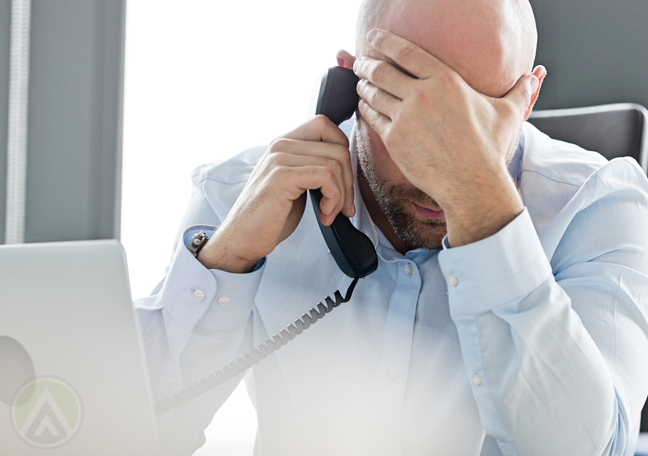 frustrated businessman using phone