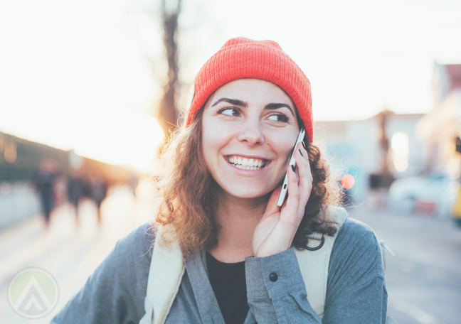 happy young woman in red bonnet making phone call