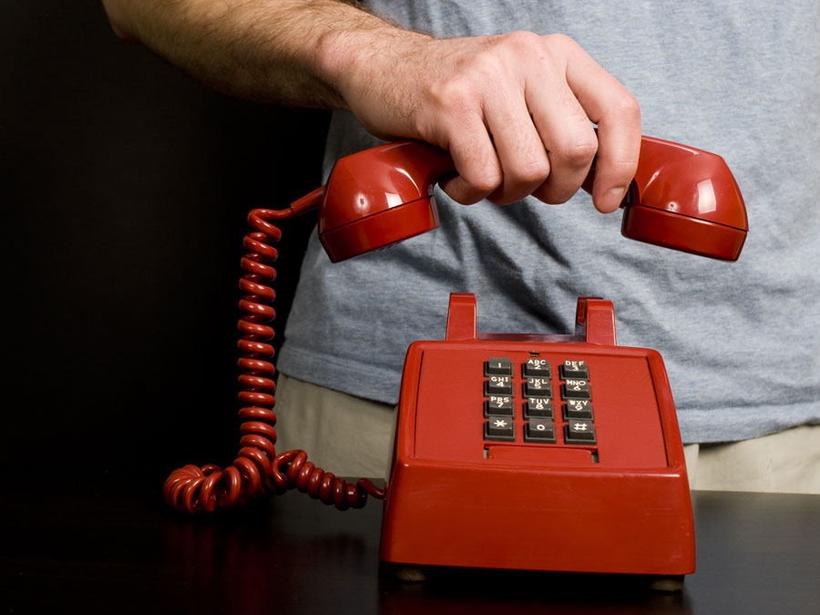how to handle abusive customers in the call center cx rep hand hanging up landline phone