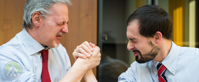 middle aged business executives partners locked in arm wrestling