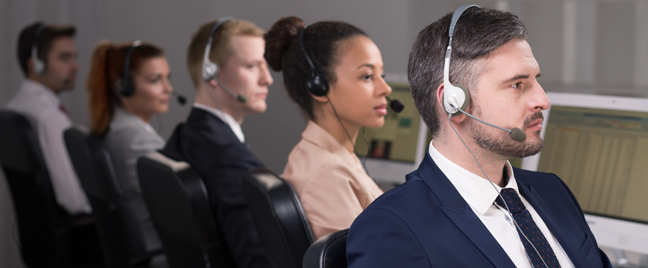 serious call center team looking off panel