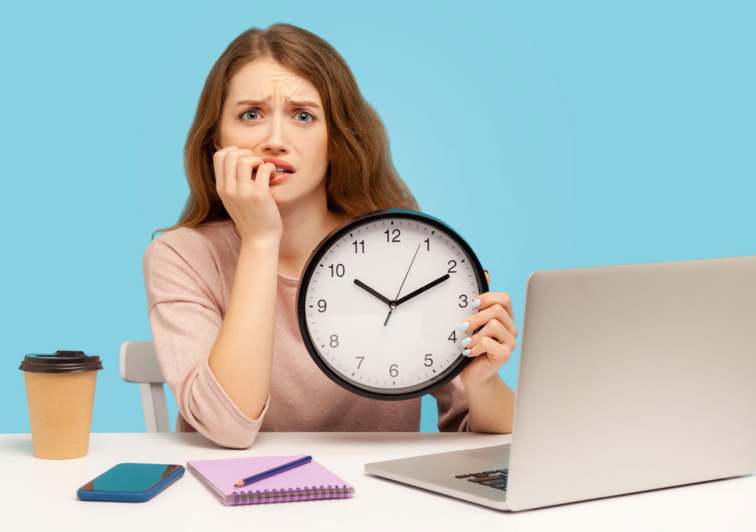 worried customer service agent biting nails by laptop in call center