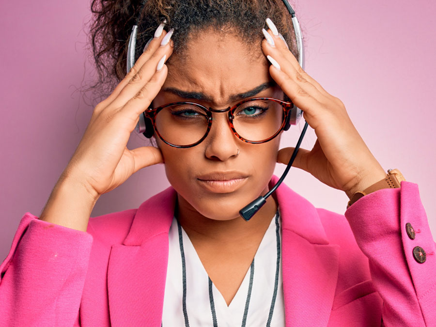 young call center agent annoyed with headache