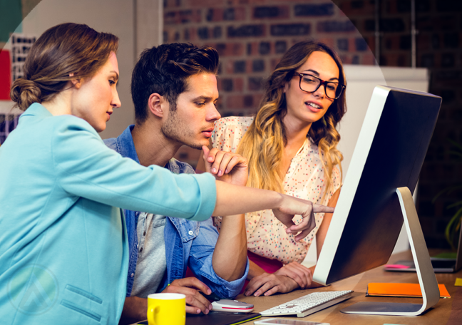 creative team discussing design at work pointing to computer screen
