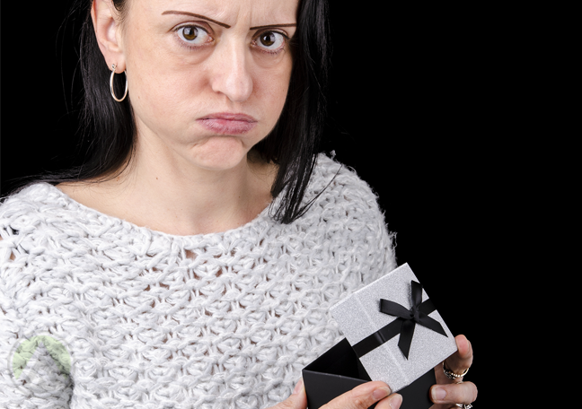 disgruntled office employee opening emplty gift box