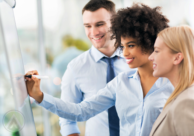 diverse business team in meeting writing on white board marker