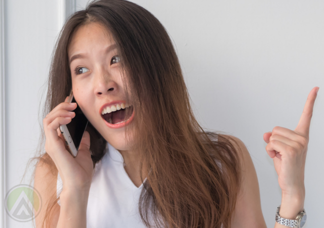 frustrated annoyed woman shoting at landline phone receiver