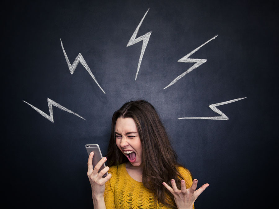 irate woman screaming at smartphone