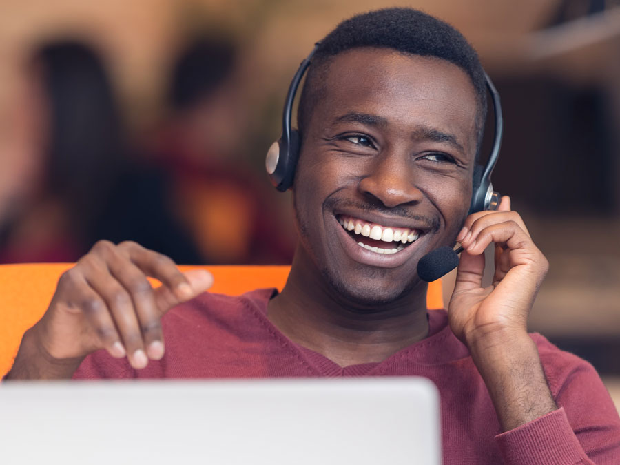 smiling delighted customer service agent in call center