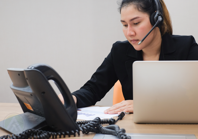 customer service rep in call center using phone unit 