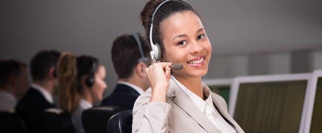 smiling female call center agent next to busy customer service reps