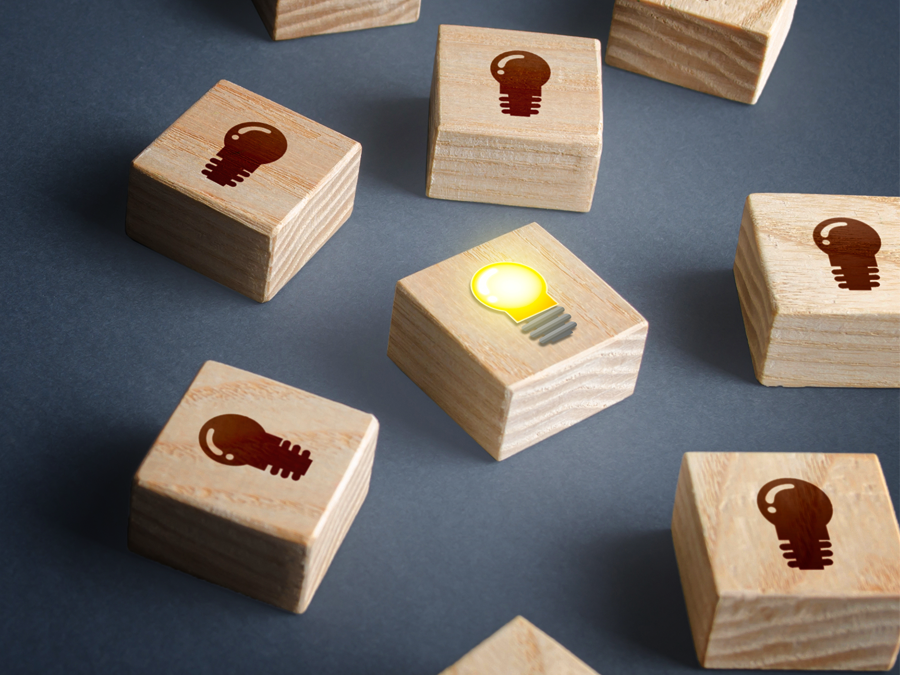 startup company competitive advantage depiction wood blocks lightbulb bright ideas