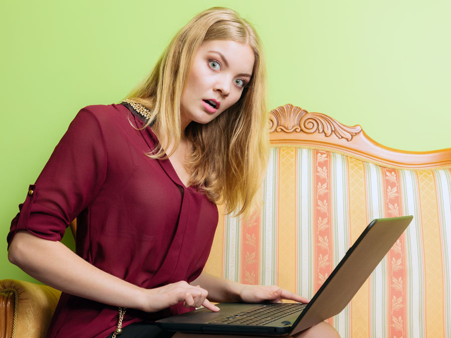 surprised disappointed business executive using laptop