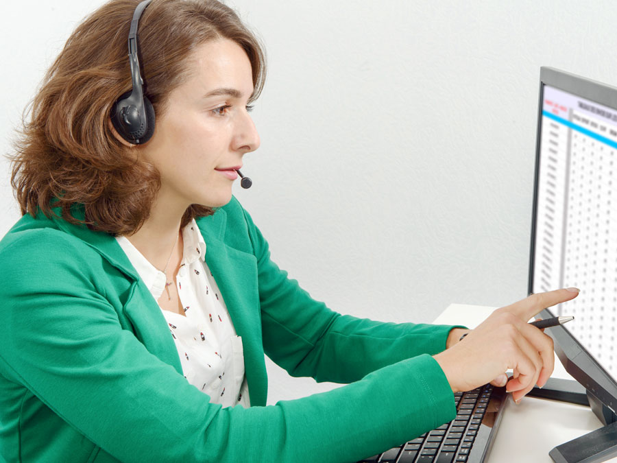 customer experience agent at call center sorting work on computer screen