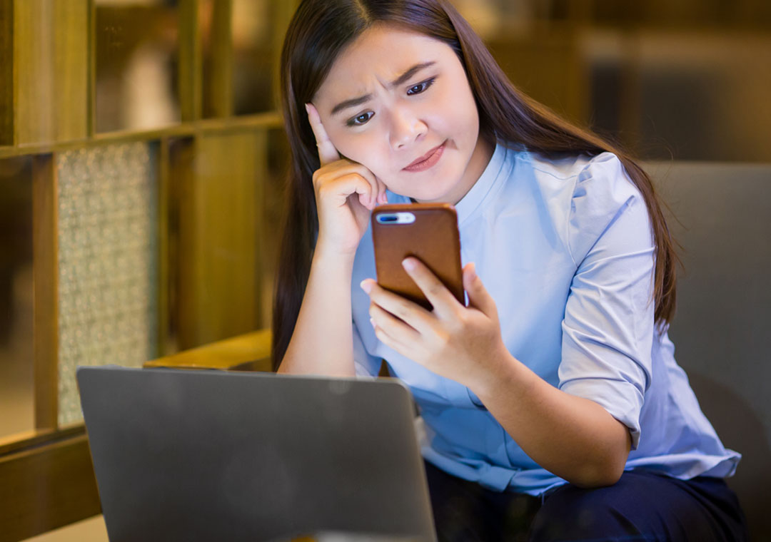 woman in coffee shop thinking deeply looking at message from customer support agent