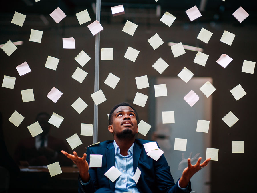 call center manager looking at multiple post it notes in office