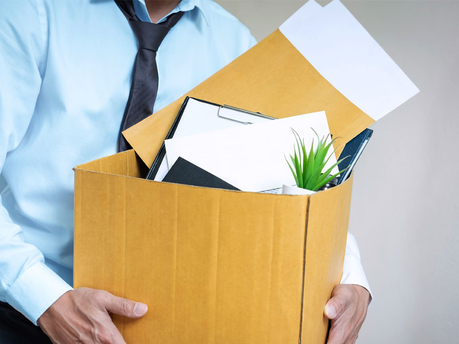 office employee resignation leaving company carrying box office items