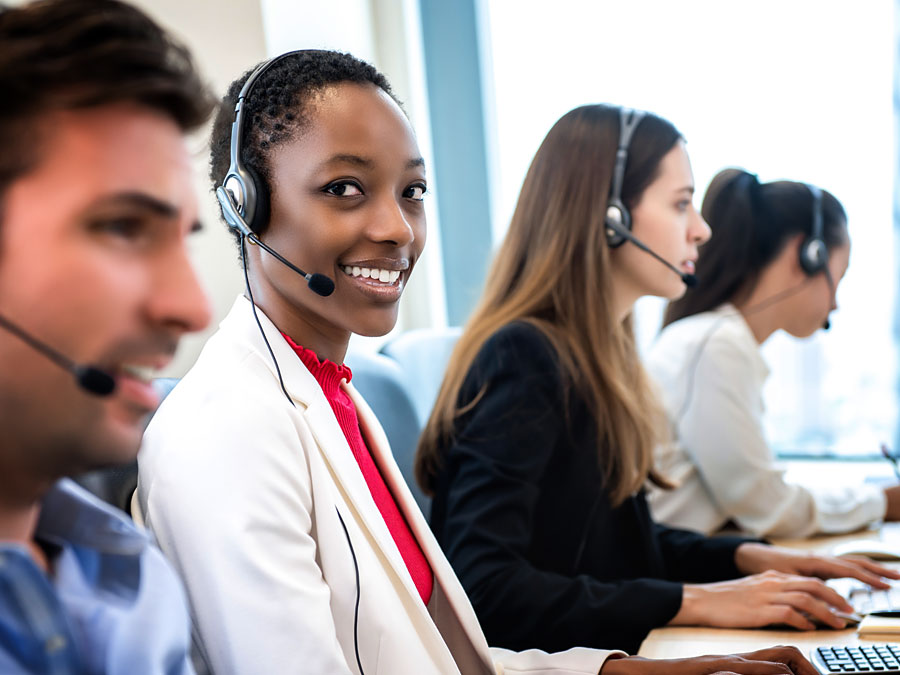 smiling customer service specialist speaking to customer in call center