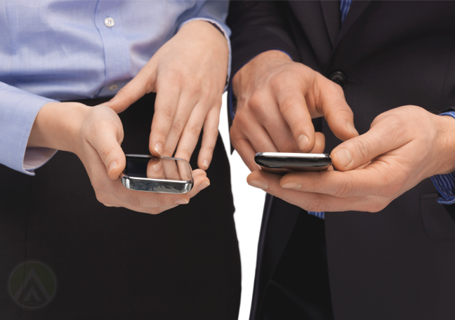 male female business executives using smartphone to read send sms text messages