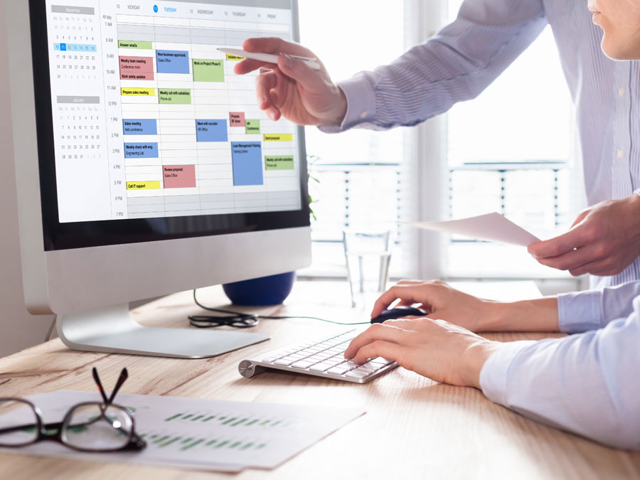 team leader assisting employee in using computer system tools