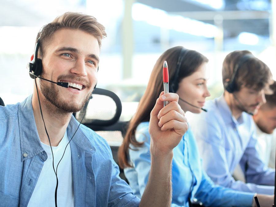happy customer support agent with call center team