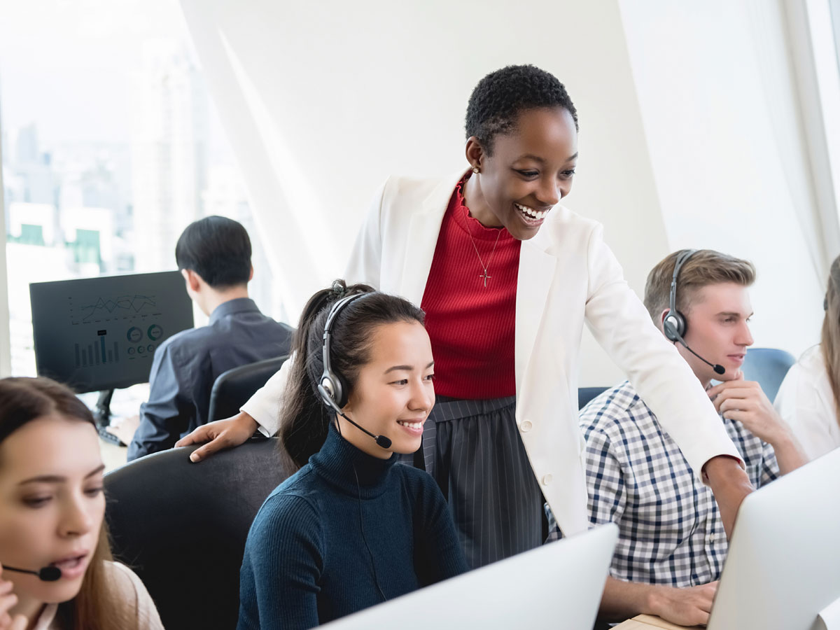 call center team leader helping diverse customer support team