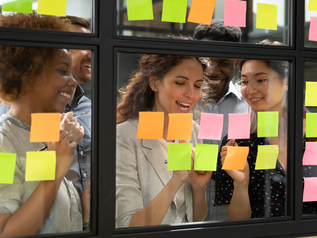 happy e-commerce team looking at post it notes