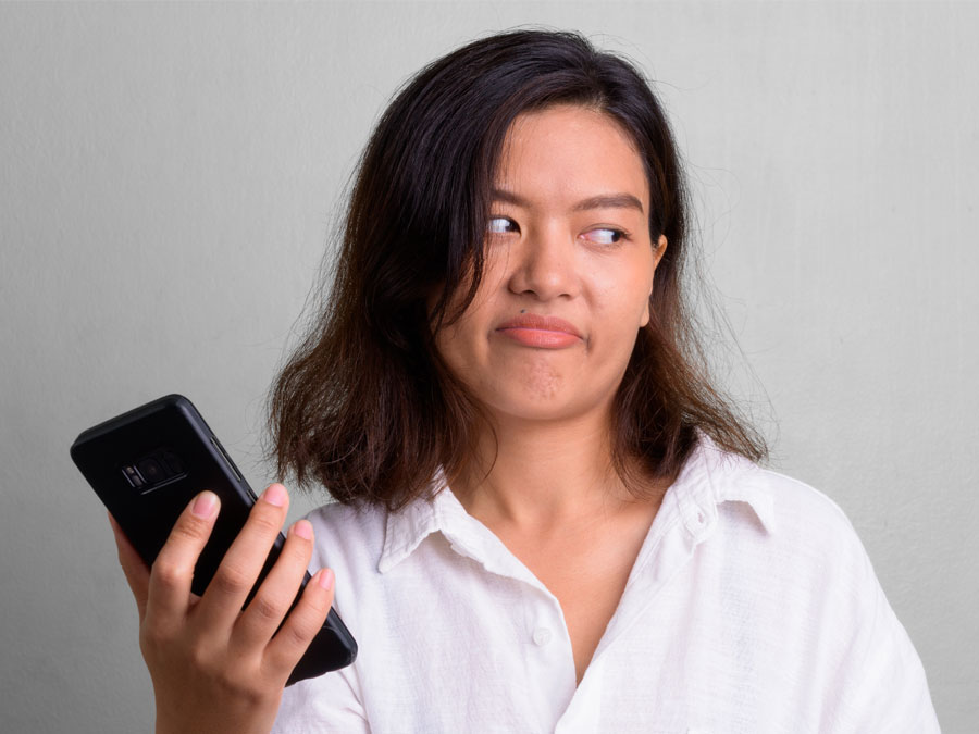 content moderation services annoyed woman rolling ayes at internet ads on smartphone
