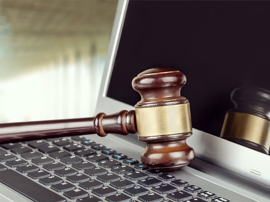 content moderation services depiction judge legal gavel on laptop