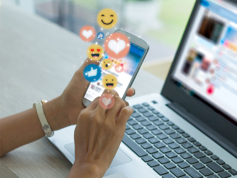 social media customer service depiction social web user on smartphone laptop like heart react icons