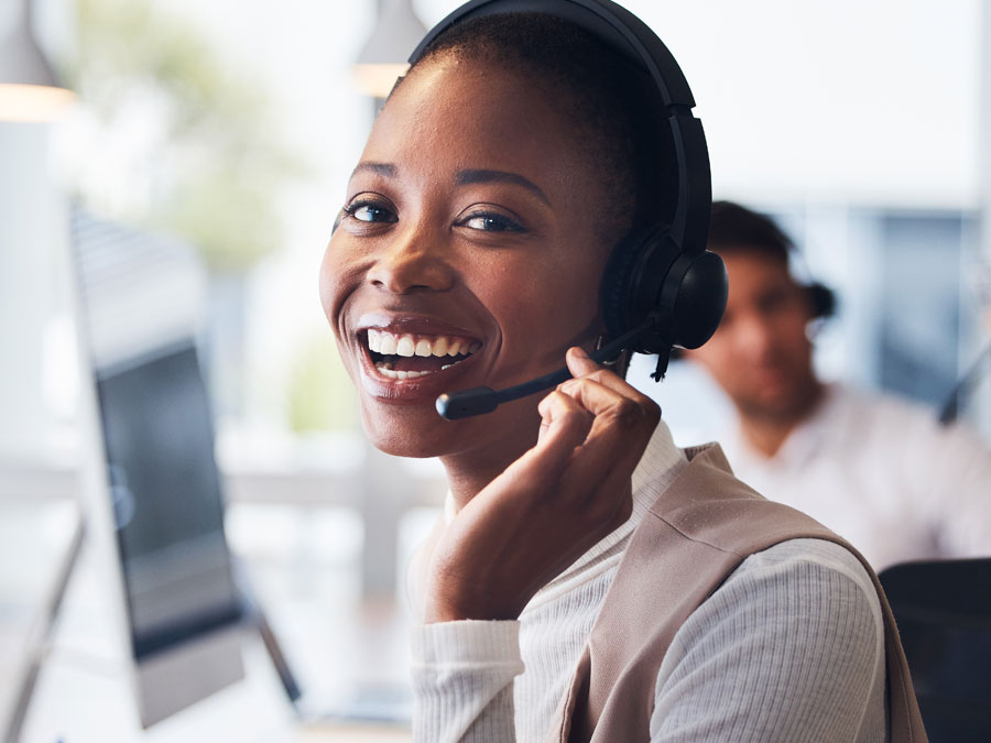 smiling ecommerce brand CX agent rep speaking to customer in call center customer support service care experience