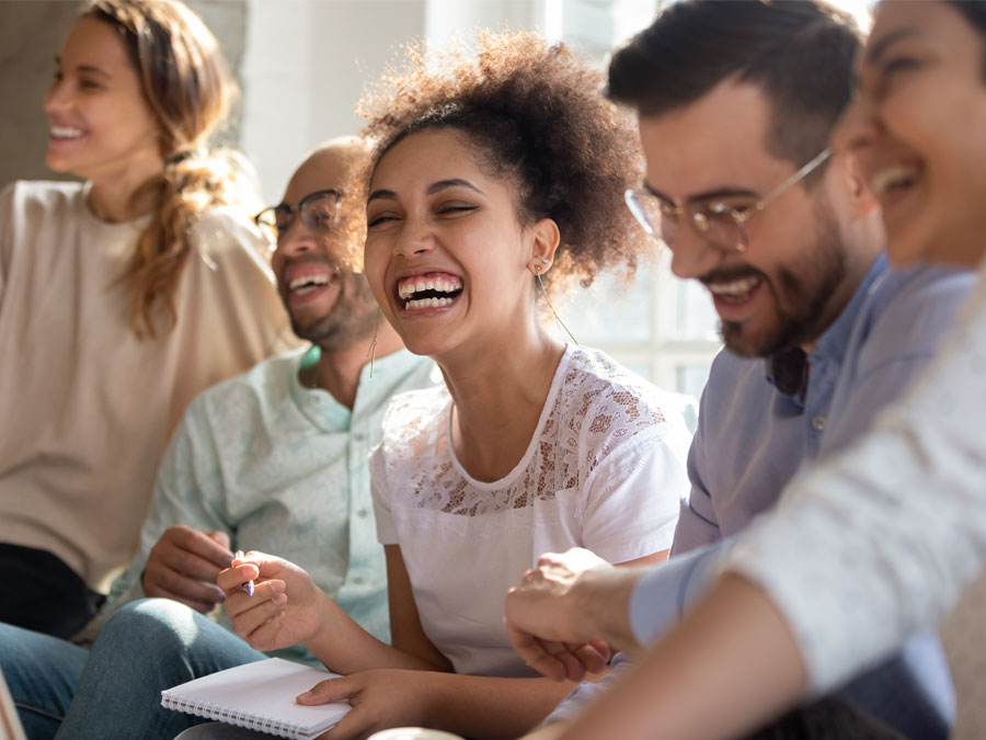 call center creativity depiction CX contact center agents reps laughing during customer service team discussion