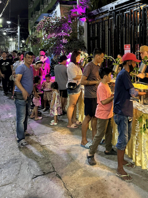 People lining up for food during the Easter Community Initiative | Open Access BPO