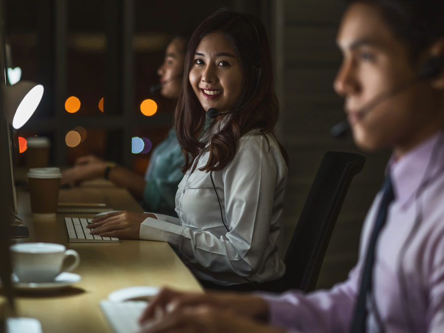 smiling customer support agent with outsourcing CX team working 24 7 call center 
