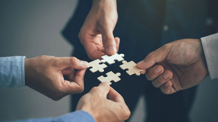 business partnership best-Customer-Experience-Strategy-depiction executive hands jigsaw puzzle