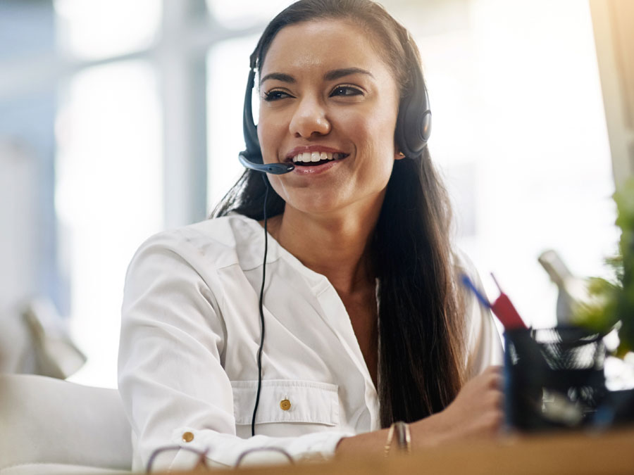 24 7 call center agent smiling assisting customer over the phone