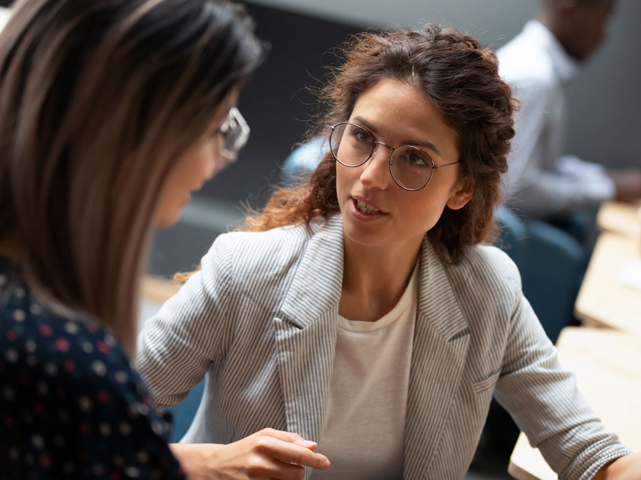 Call Center Team Leaders in huddle with customer support agent 