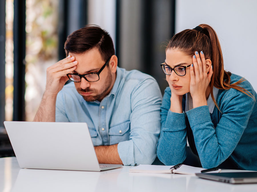 Stressed business coworkers looking at laptop oabpo price sacrifices for amazing cx