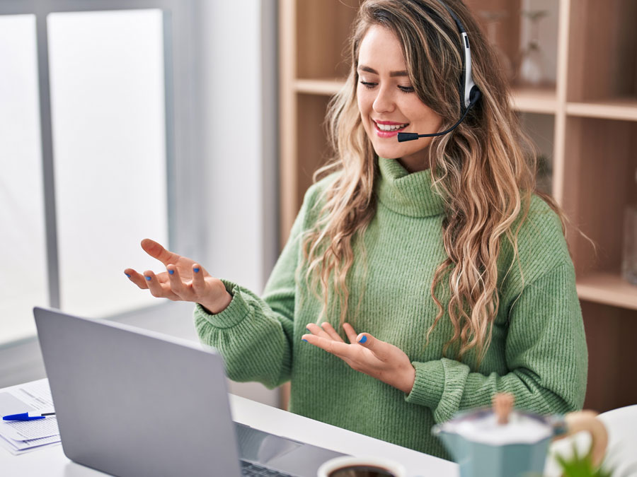 agent from call center in the Philippines assisting customer over the phone smiling