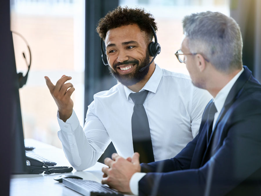 call center team leader discussing work with customer service agent