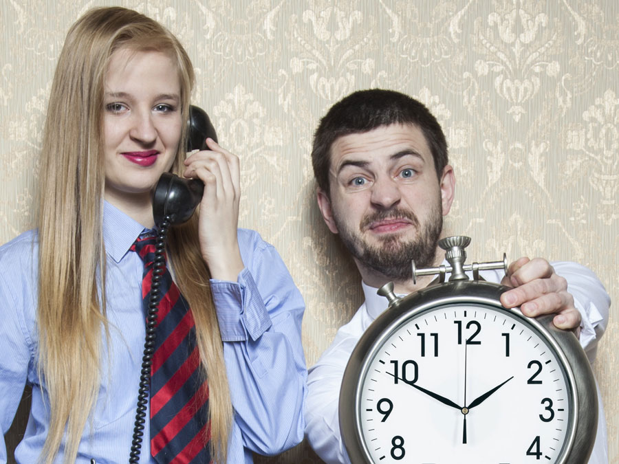 call center worker holding wall clock with customer on the phone