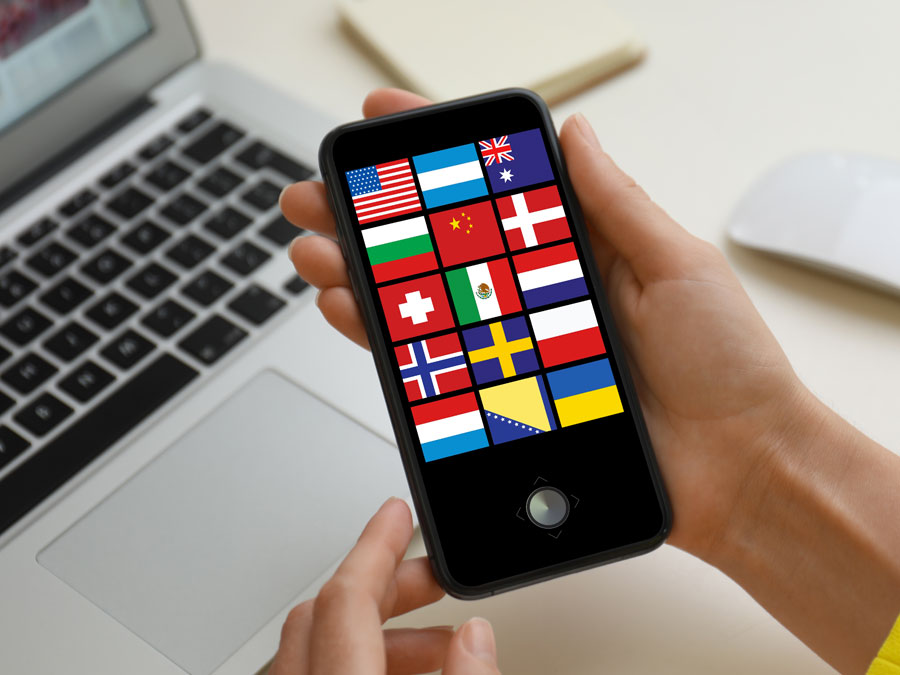 content moderator holding smartphone with international flags